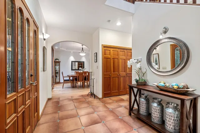 a living room with furniture and large windows