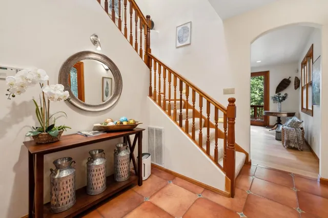 a living room with furniture large window and a flat screen tv