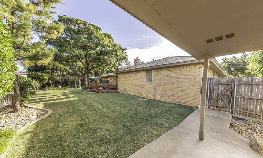 3620 93rd Street Lubbock, TX 79423 - Photo 32 of 33 a view of a yard with wooden fence