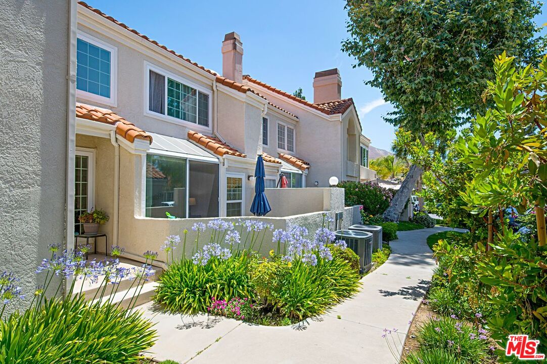 4240 Lost Hills Road, Unit 2602 Calabasas, CA 91301 - Photo 1 of 38 a front view of a house with garden