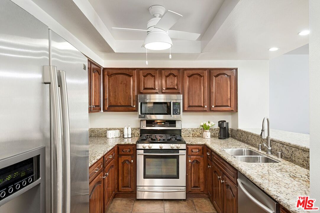 4240 Lost Hills Road, Unit 2602 Calabasas, CA 91301 - Photo 11 of 38 a kitchen with a sink stove and microwave