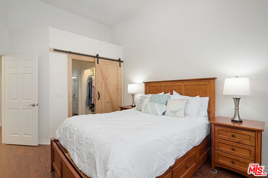 4240 Lost Hills Road, Unit 2602 Calabasas, CA 91301 - Photo 20 of 38 a bedroom with a bed and a night stand