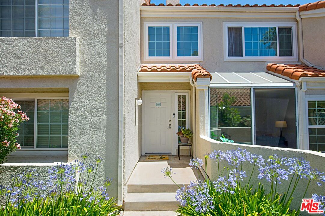 4240 Lost Hills Road, Unit 2602 Calabasas, CA 91301 - Photo 2 of 38 a front view of a house with a garden