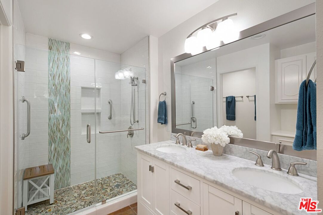 4240 Lost Hills Road, Unit 2602 Calabasas, CA 91301 - Photo 23 of 38 a bathroom with a double vanity sink mirror and shower