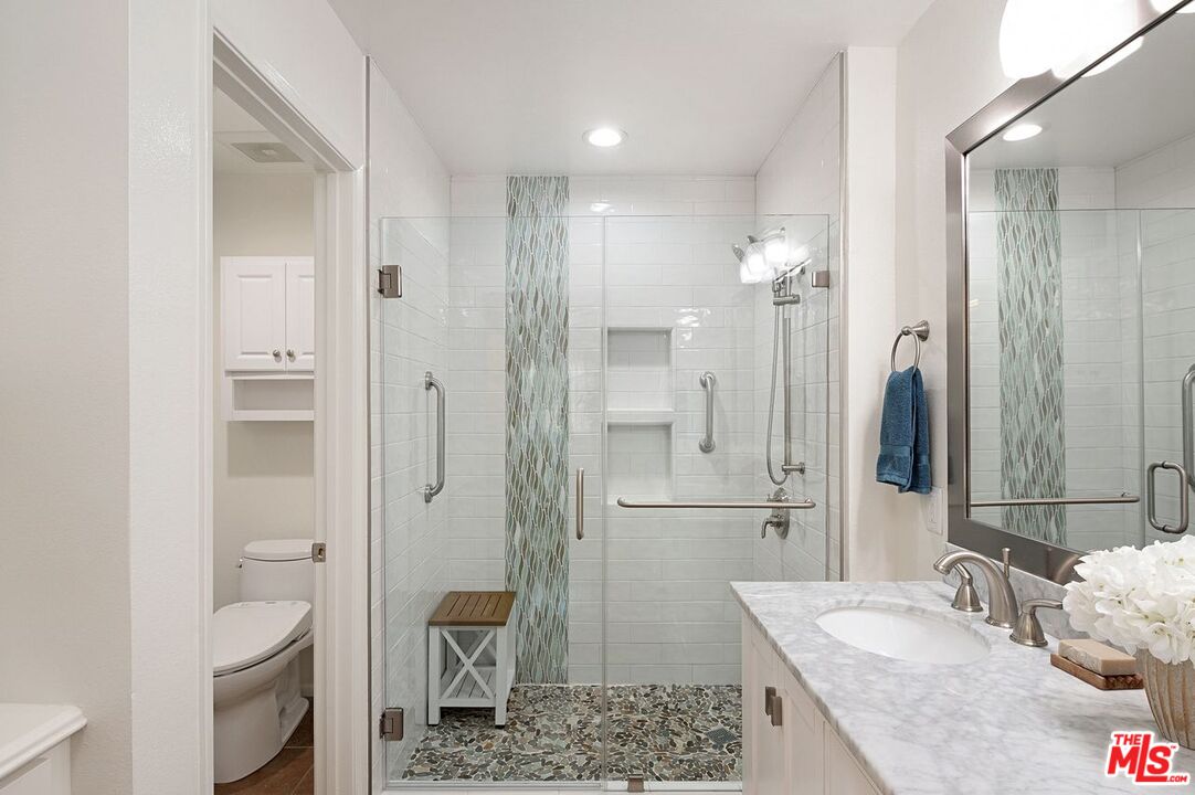 4240 Lost Hills Road, Unit 2602 Calabasas, CA 91301 - Photo 24 of 38 a bathroom with a granite countertop sink a toilet and shower