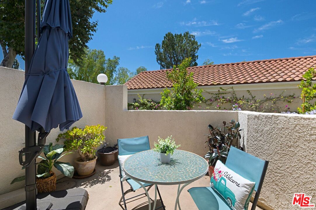 4240 Lost Hills Road, Unit 2602 Calabasas, CA 91301 - Photo 28 of 38 a view of a chairs and table in a patio