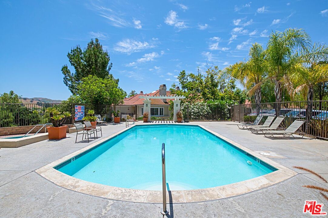 4240 Lost Hills Road, Unit 2602 Calabasas, CA 91301 - Photo 31 of 38 a view of a swimming pool with lounge chairs