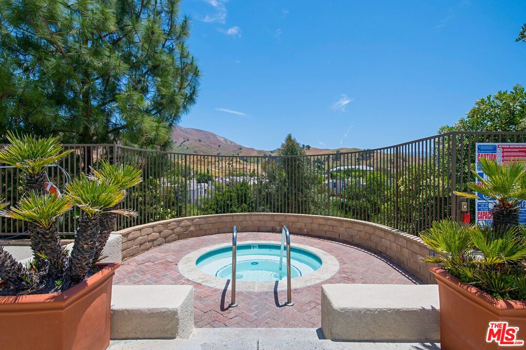 4240 Lost Hills Road, Unit 2602 Calabasas, CA 91301 - Photo 32 of 38 a view of a backyard with plants and swimming pool