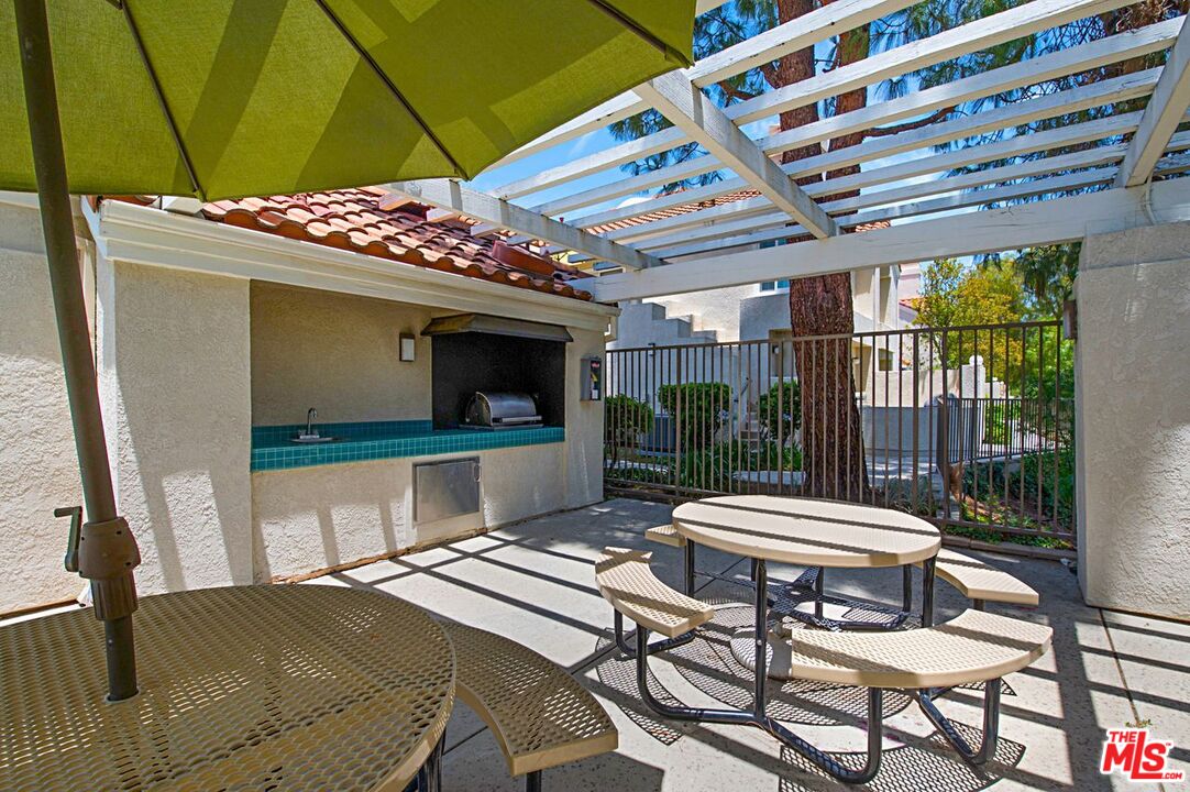4240 Lost Hills Road, Unit 2602 Calabasas, CA 91301 - Photo 34 of 38 a room with furniture and a flat screen tv