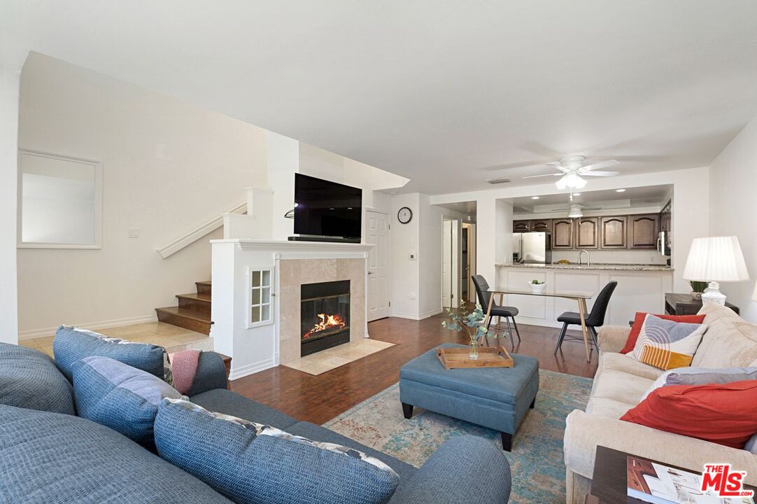 4240 Lost Hills Road, Unit 2602 Calabasas, CA 91301 - Photo 7 of 38 a living room with furniture a fireplace and a flat screen tv