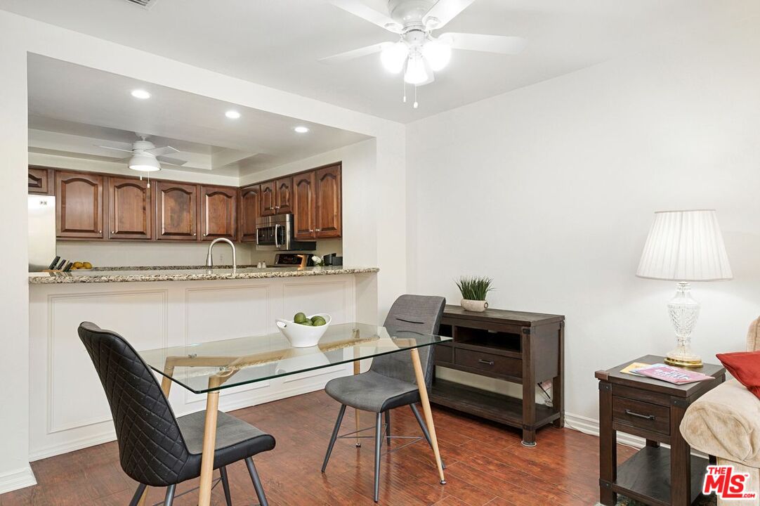 4240 Lost Hills Road, Unit 2602 Calabasas, CA 91301 - Photo 9 of 38 a living room with stainless steel appliances kitchen island granite countertop furniture and a wooden floor