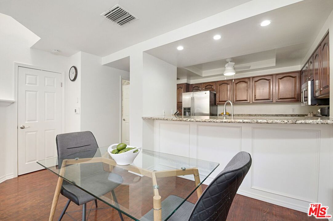 4240 Lost Hills Road, Unit 2602 Calabasas, CA 91301 - Photo 10 of 38 a living room with stainless steel appliances furniture a dining table and kitchen view