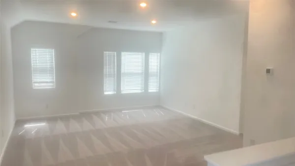 an empty room with windows and closet