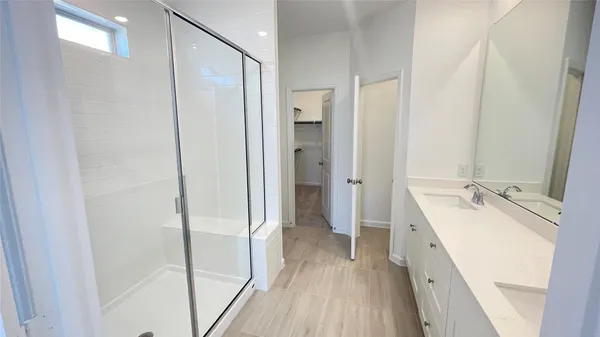 a bathroom with a double vanity sink and mirror