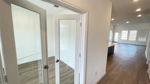 a view of a hallway with wooden floor and staircase