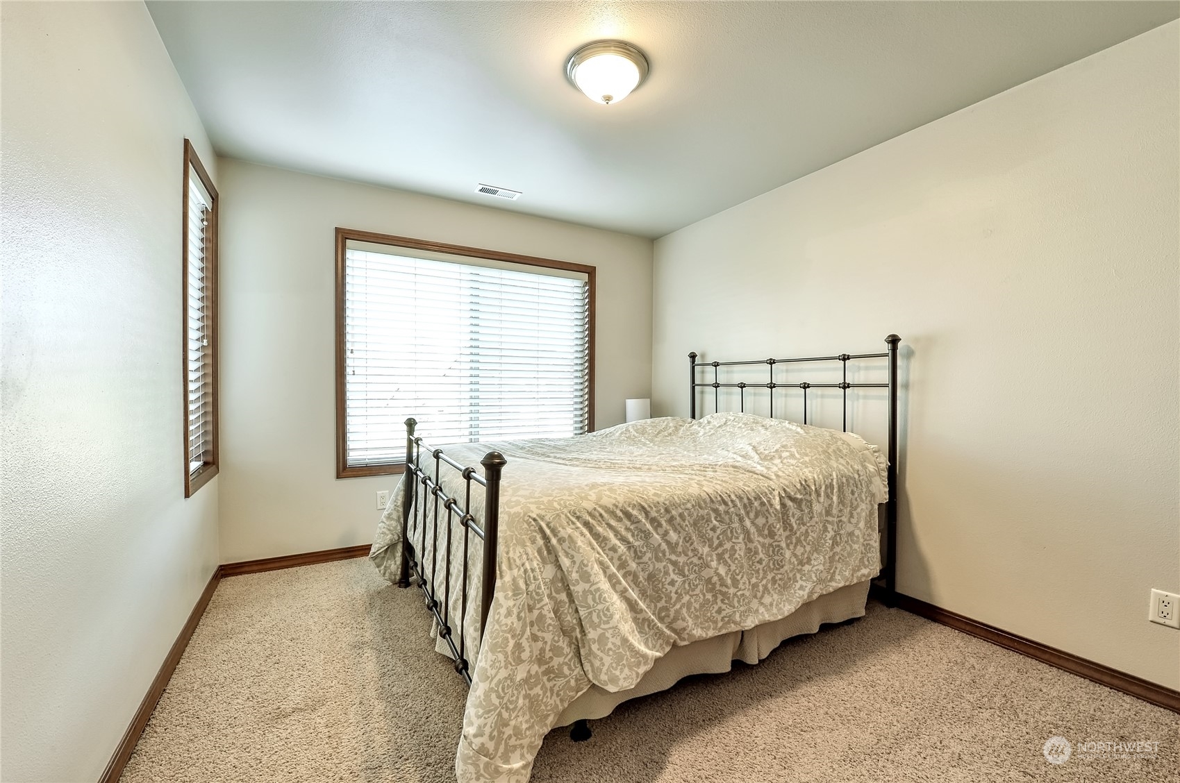5576 Old Settler Drive Ferndale, WA 98248 - Photo 14 of 20 a bedroom with a bed and table lamp