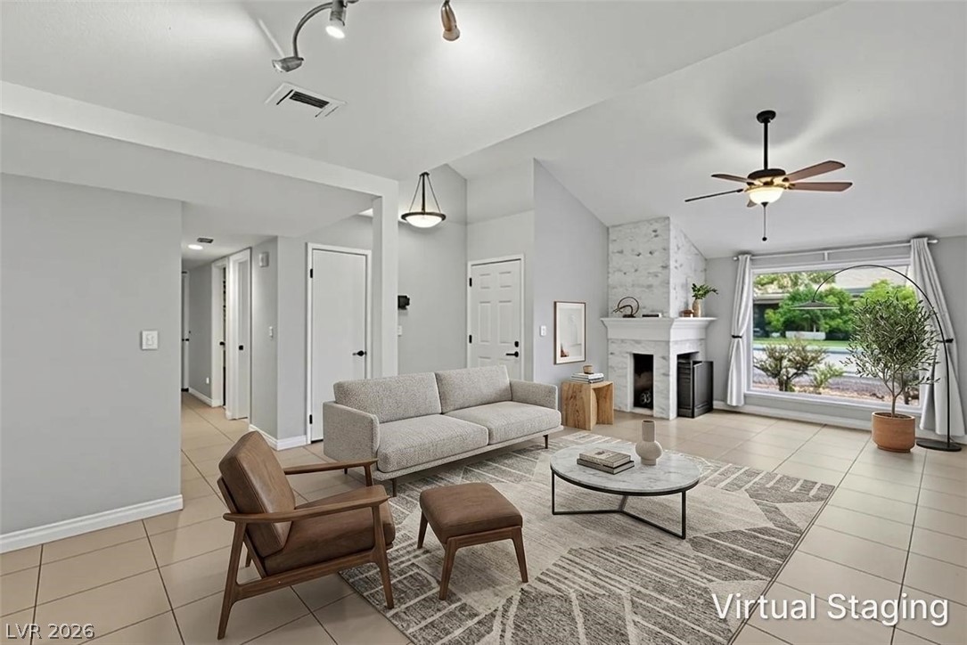 5620 Roseridge Avenue Las Vegas, NV 89107 - Photo 5 of 55 Virtual Staging: Bright and airy living room with vaulted ceilings, featuring a classic fireplace and large window.