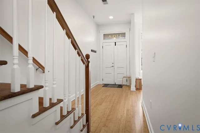 a view of entryway with wooden floor and stairs