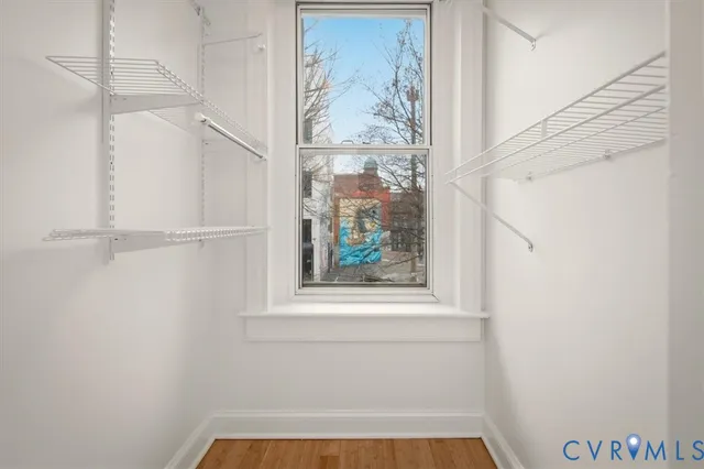 a view of a small space with wooden floor and a window