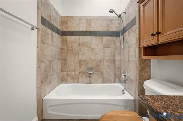 a bathroom with a toilet and bathtub