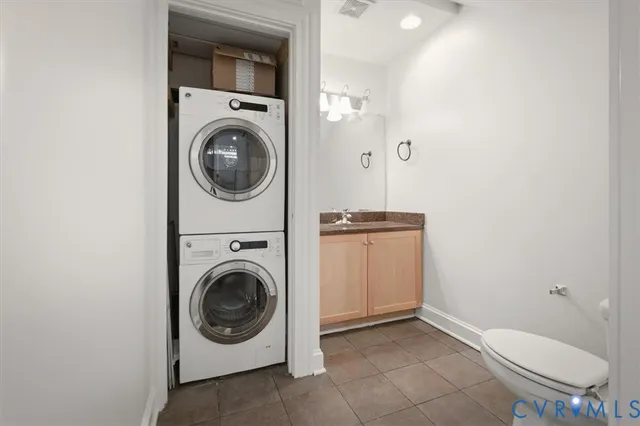 a utility room with sink dryer and washer