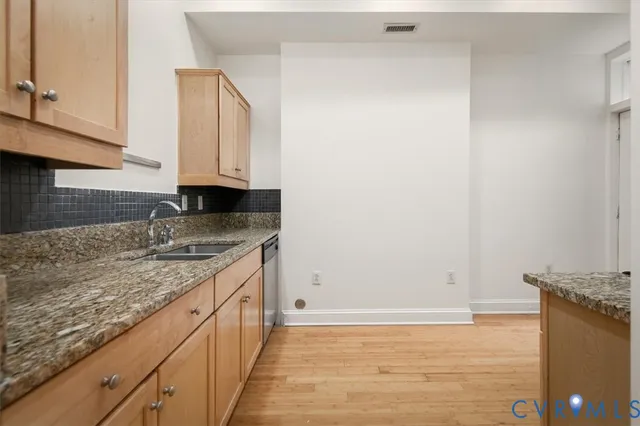 a kitchen with granite countertop cabinets and sink