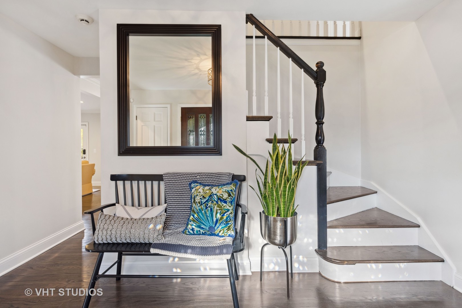 2S540 White Birch Lane Wheaton, IL 60189 - Photo 9 of 46 a view of a hallway with wooden floor and a potted plant