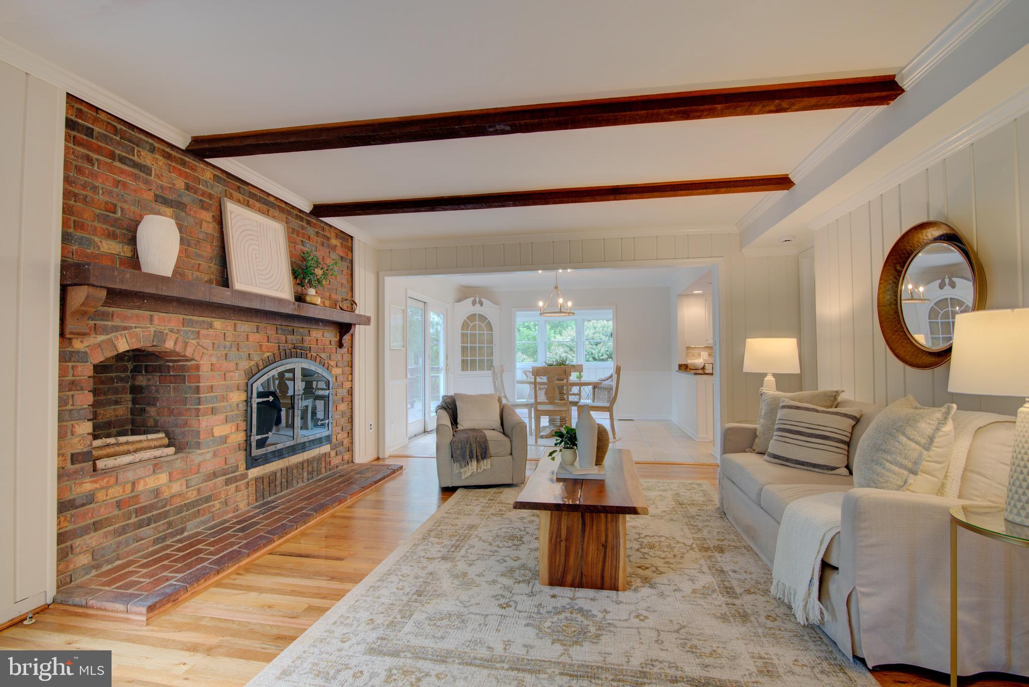 10405 Trumpeter Court Vienna, VA 22182 - Photo 12 of 43 a living room with furniture a fireplace and a floor to ceiling window