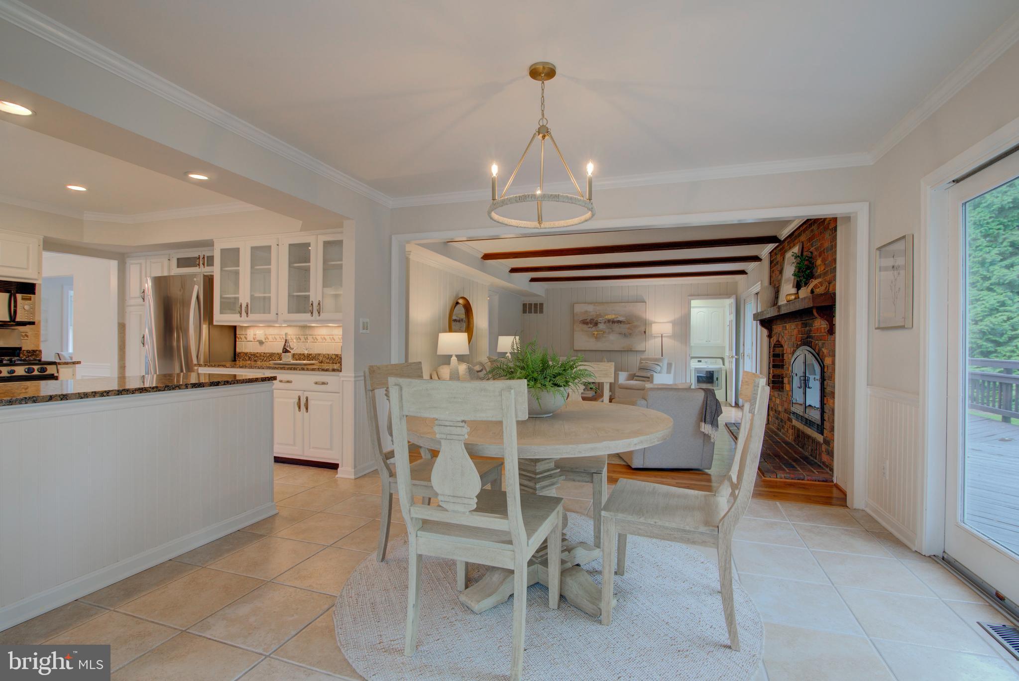 10405 Trumpeter Court Vienna, VA 22182 - Photo 14 of 43 a dining room with furniture a chandelier and kitchen view