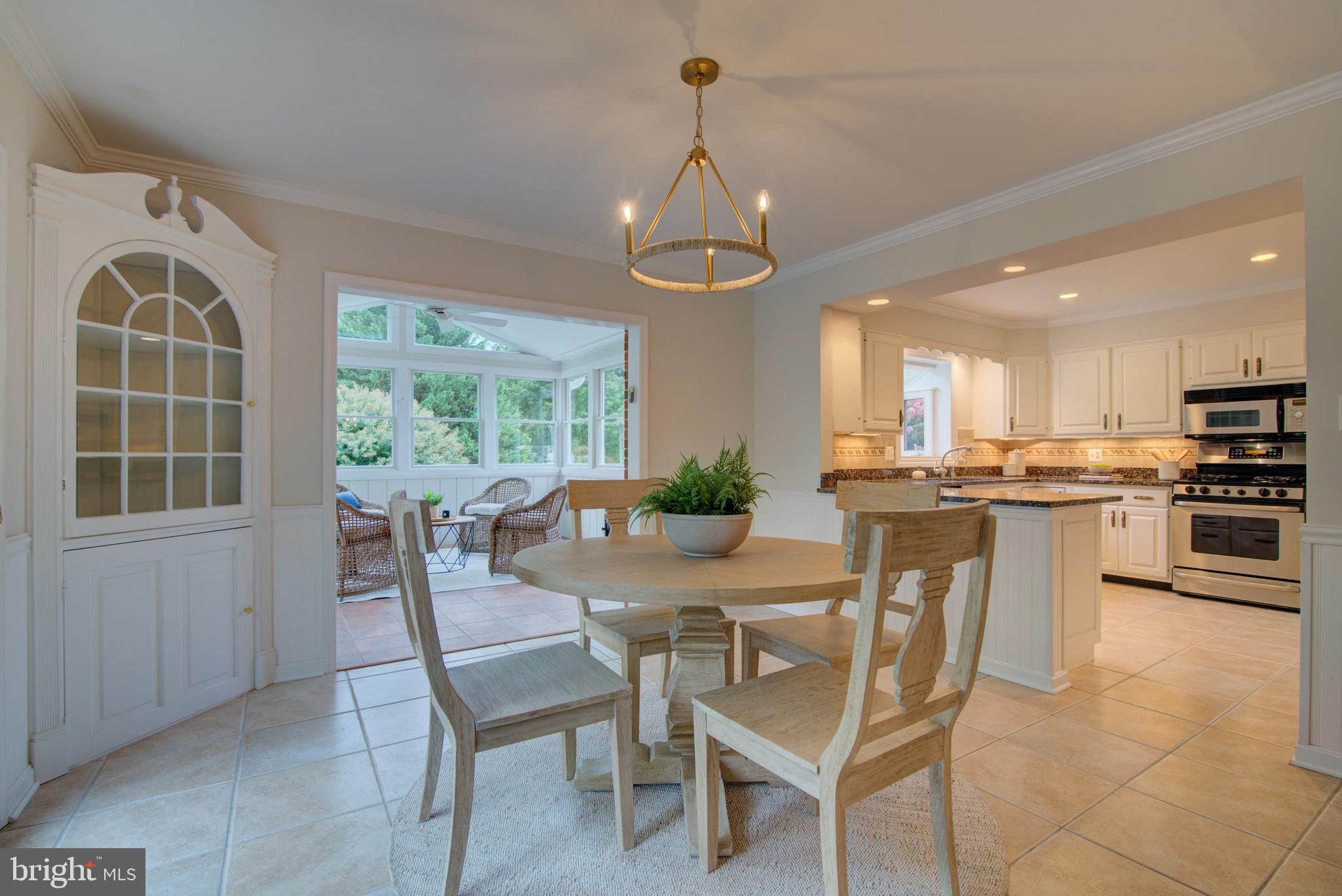 10405 Trumpeter Court Vienna, VA 22182 - Photo 15 of 43 a dining room with wooden floor a chandelier a wooden table and chairs