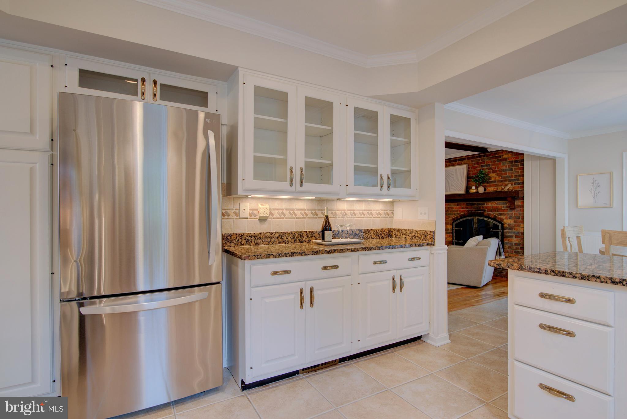 10405 Trumpeter Court Vienna, VA 22182 - Photo 19 of 43 a kitchen with stainless steel appliances a refrigerator and cabinets