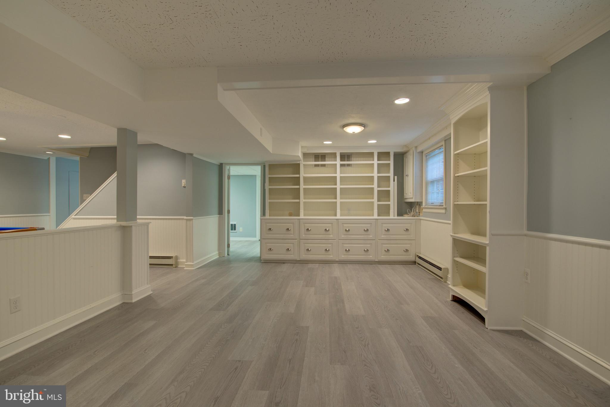 10405 Trumpeter Court Vienna, VA 22182 - Photo 32 of 43 an empty room with wooden floor and windows