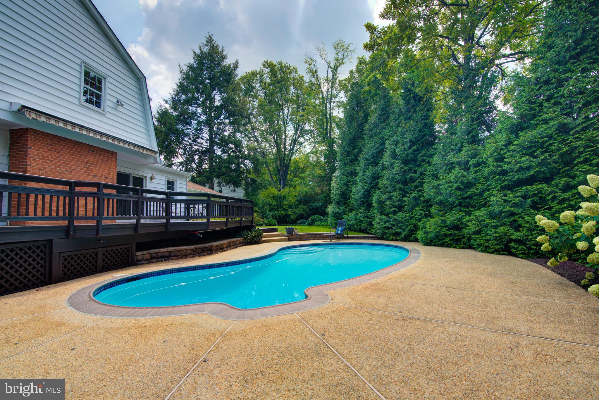 10405 Trumpeter Court Vienna, VA 22182 - Photo 38 of 43 a view of a swimming pool with a yard and trees