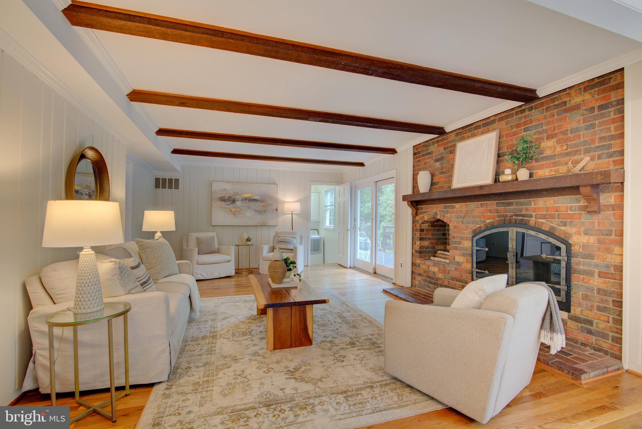 10405 Trumpeter Court Vienna, VA 22182 - Photo 10 of 43 a living room with furniture a lamp and a fireplace