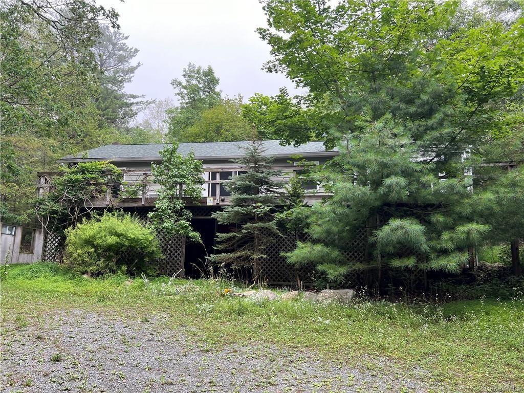 a view of a garden with a bench and trees
