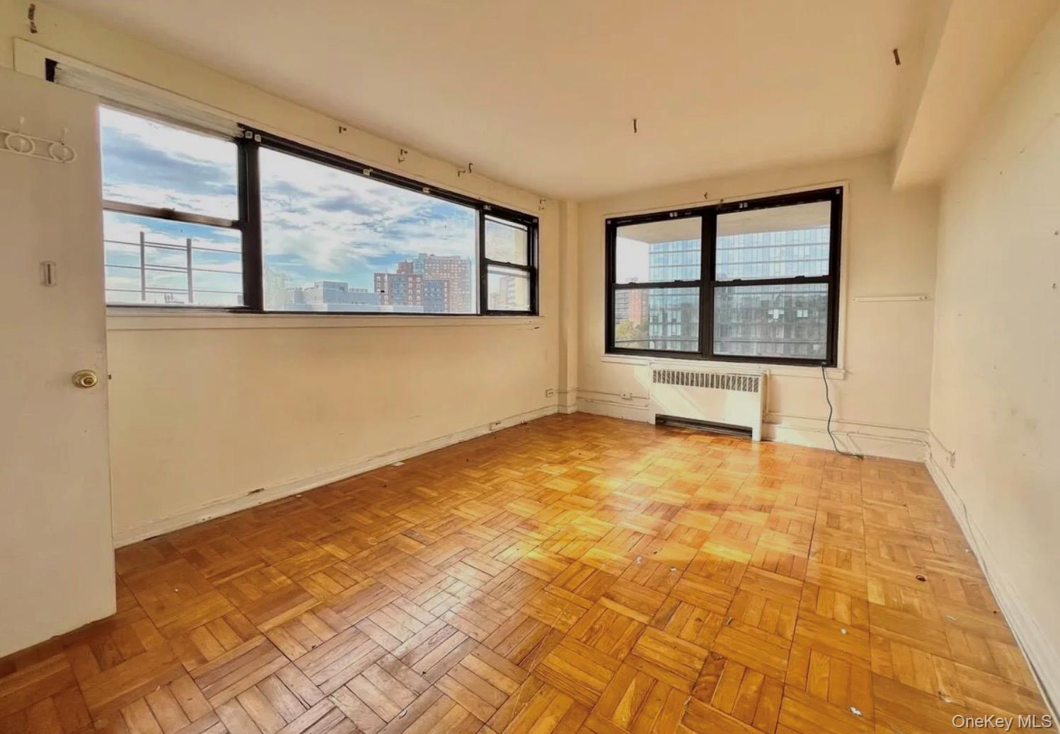 98-22 63rd Drive, Unit 7B Queens, NY 11374 - Photo 3 of 10 a view of an empty room with a window