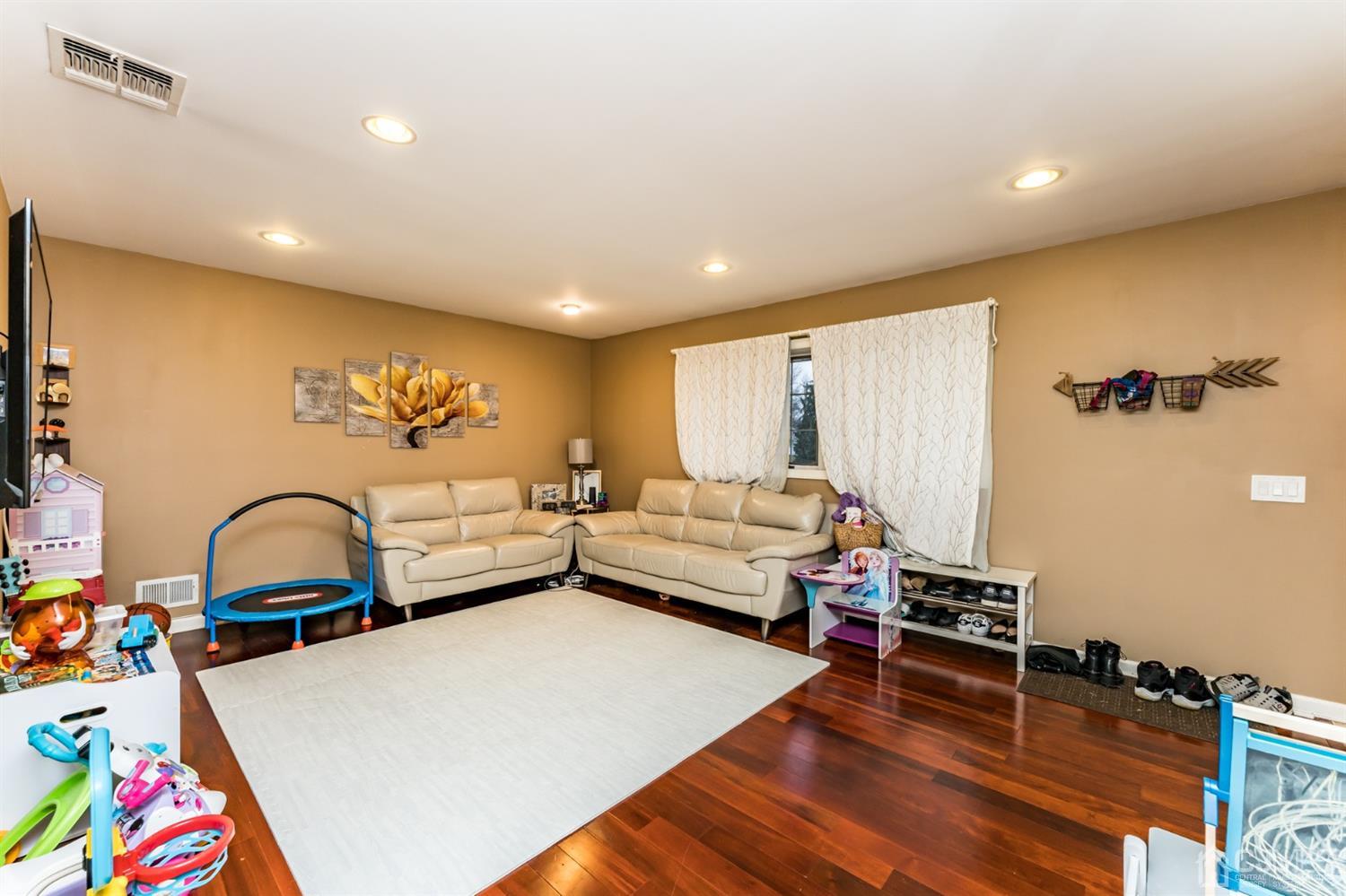 27 Fairfax Road Edison, NJ 08817 - Photo 4 of 25 a bedroom with furniture and a wooden floor