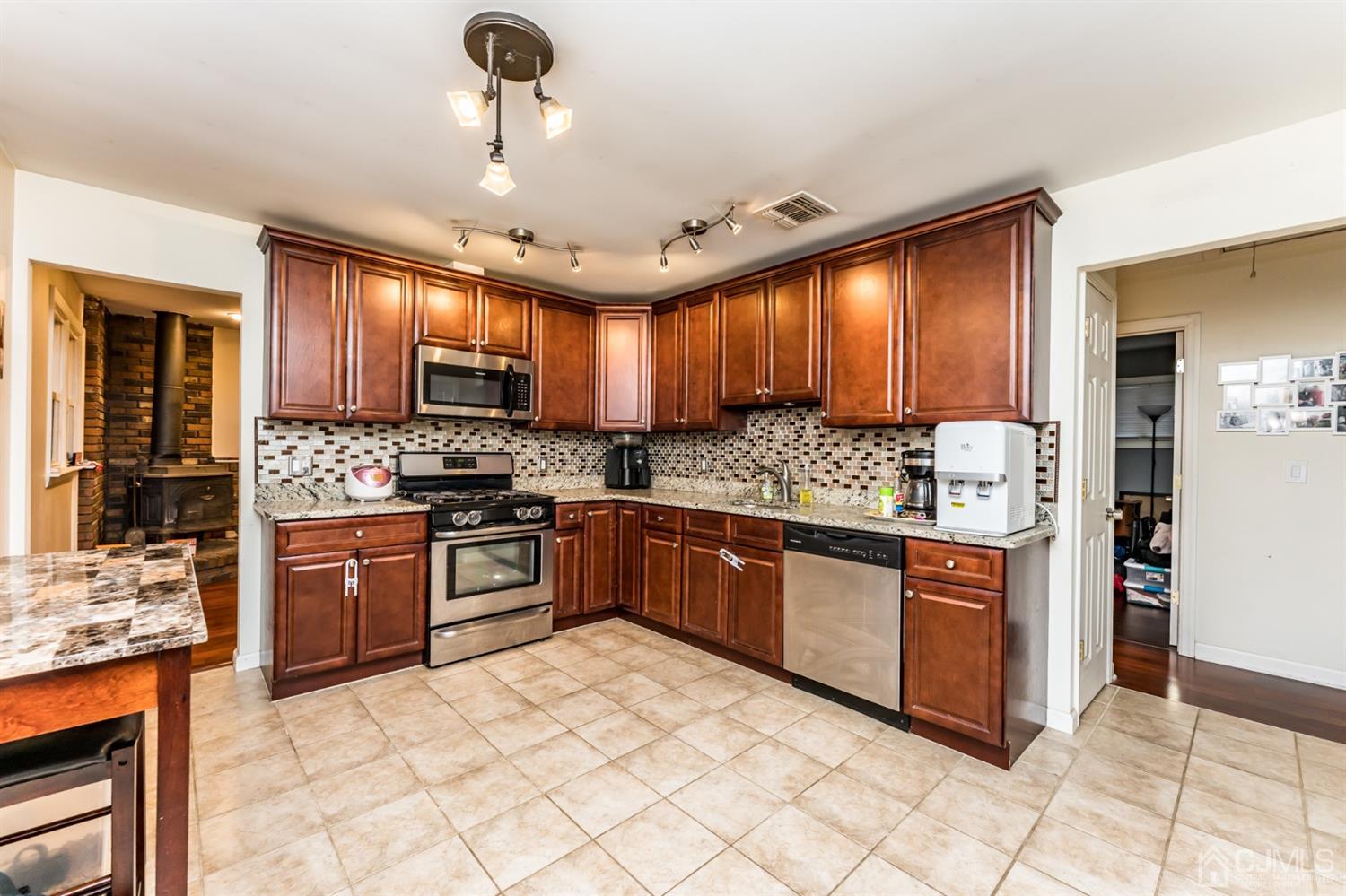 27 Fairfax Road Edison, NJ 08817 - Photo 7 of 25 a kitchen with stainless steel appliances granite countertop a stove sink and cabinets
