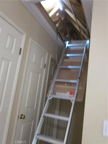 a view of an empty room with closet and a window