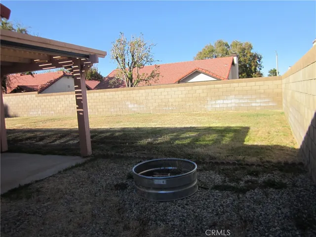 a view of a porch with a floor to ceiling window and wooden fence