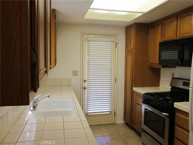 a stove top oven sitting inside of a kitchen
