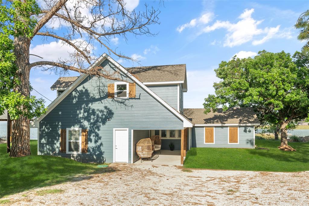 1907 Buck Run Graford, TX 76449 - Photo 13 of 33 a front view of a house with a yard and trees