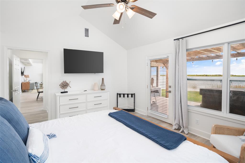 1907 Buck Run Graford, TX 76449 - Photo 16 of 33 a bedroom with a bed and a flat screen tv