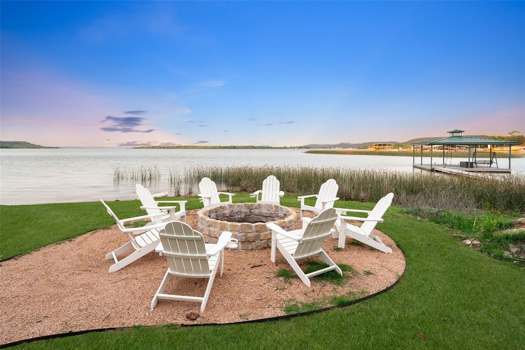 1907 Buck Run Graford, TX 76449 - Photo 33 of 33 a view of a lake with couches chairs and a table