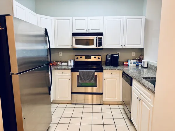 a kitchen with a stove top oven and cabinets
