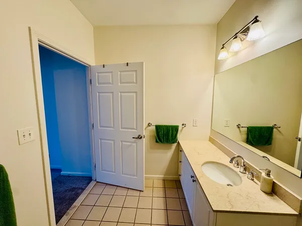a bathroom with a sink a vanity and a mirror