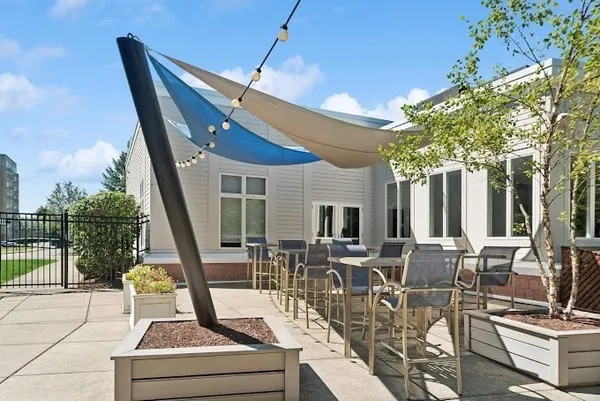 a view of the patio with couches and dining table with chairs