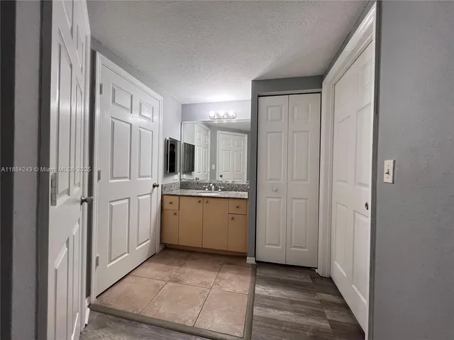 a bathroom with a sink a mirror and a shower