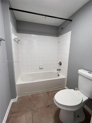 a bathroom with a toilet a sink and bathtub