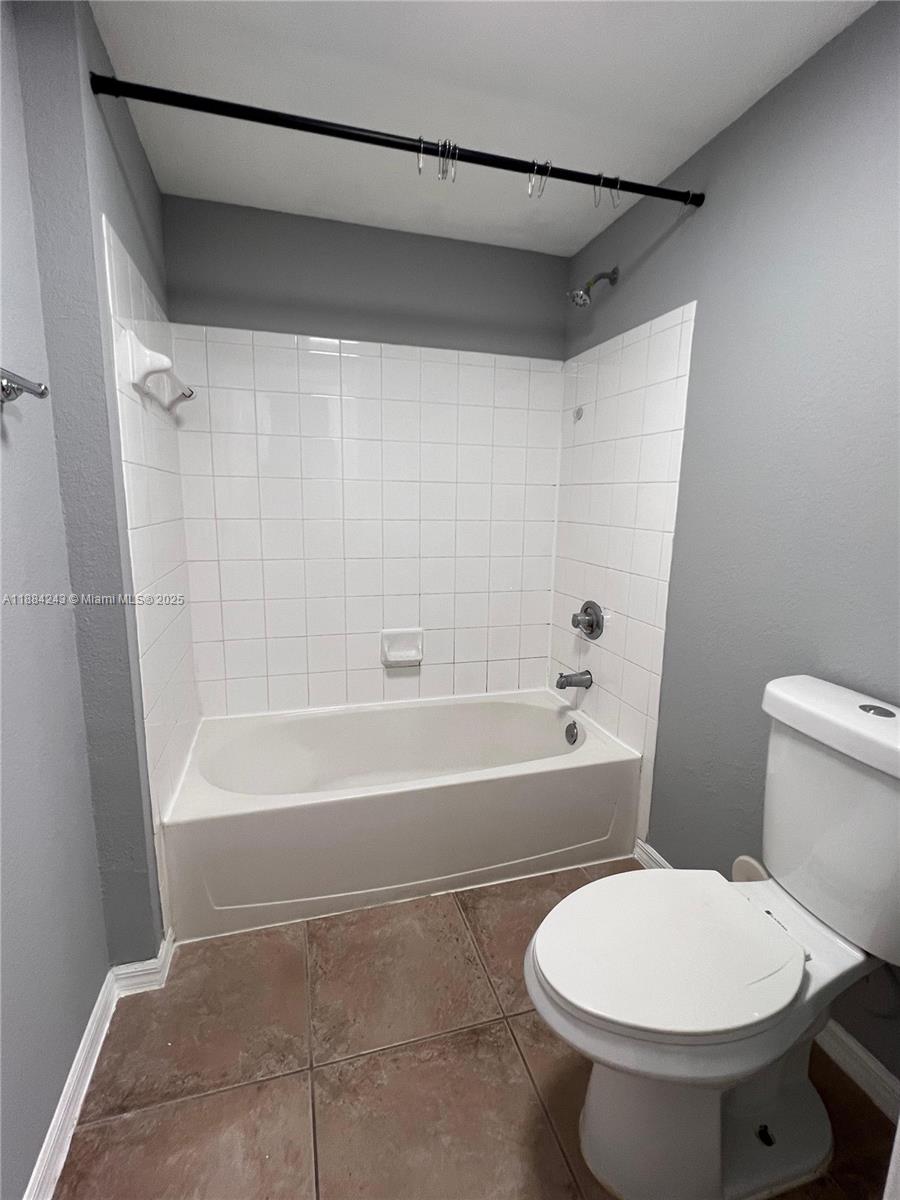 2400 Centergate Drive, Unit 102 Miramar, FL 33025 - Photo 9 of 12 a bathroom with a toilet a sink and bathtub